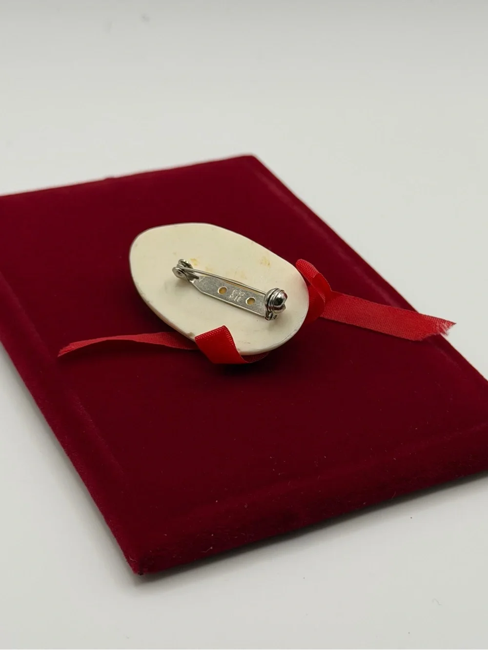 Vintage Face Brooch with Red Ribbon Accent